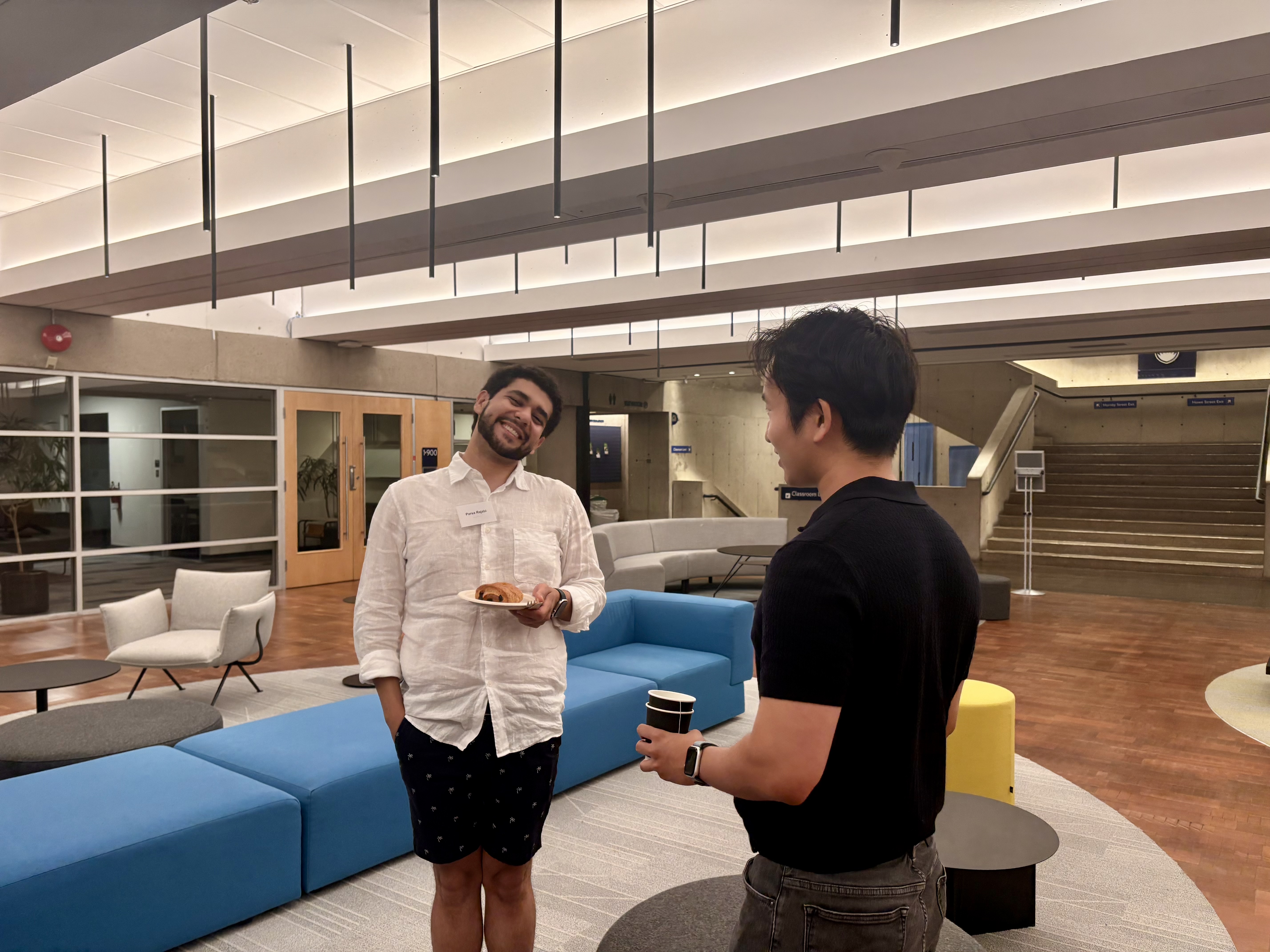 Two people talking at the Vancouver AI Safety Mixer