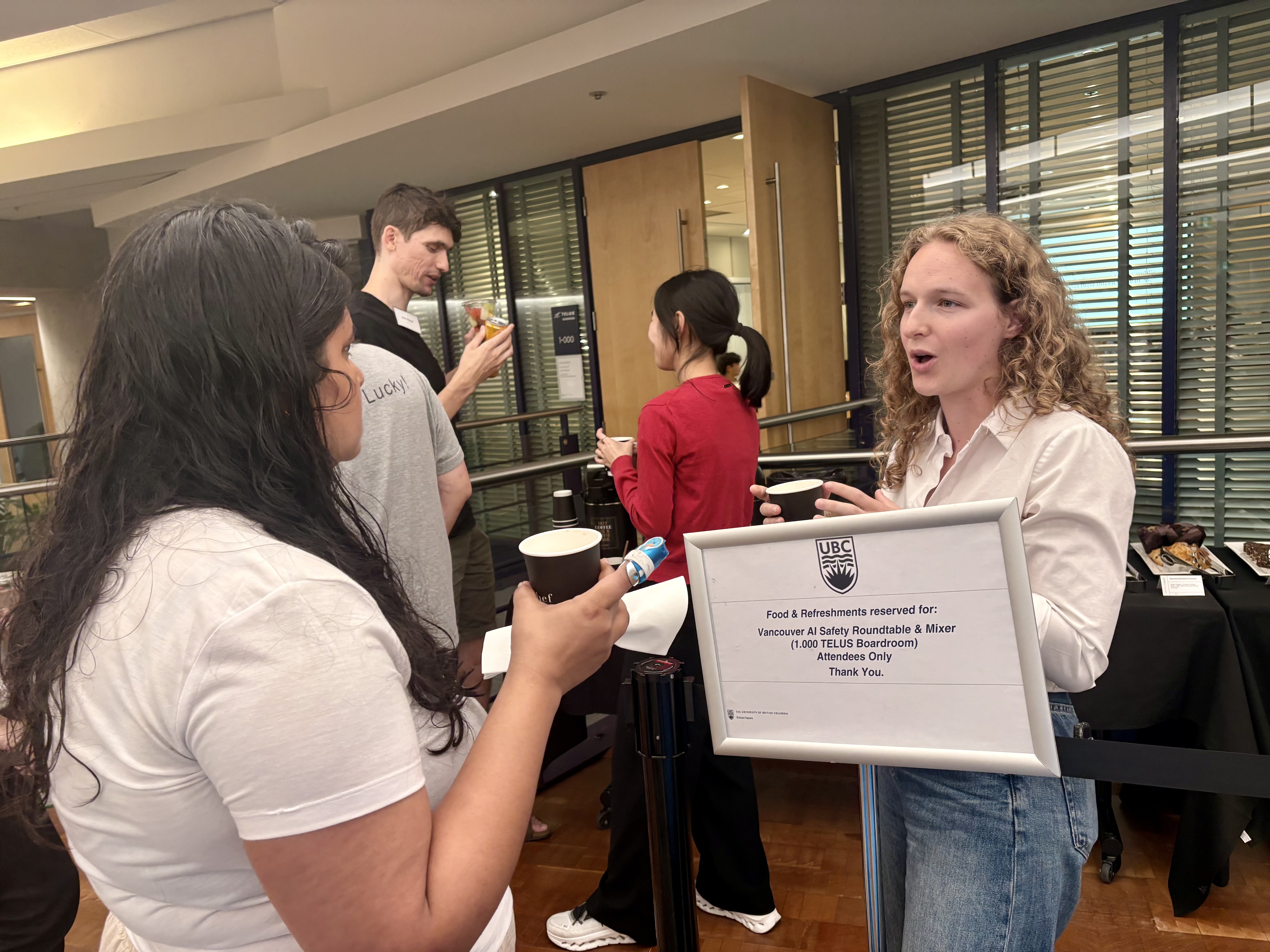 Guests talking over coffee at the Vancouver AI Safety Mixer